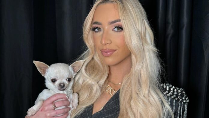 GK Barry with a white dog in her hands