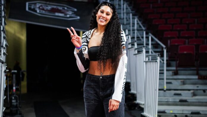 Kamilla Cardoso pictured smiling inside basketball court