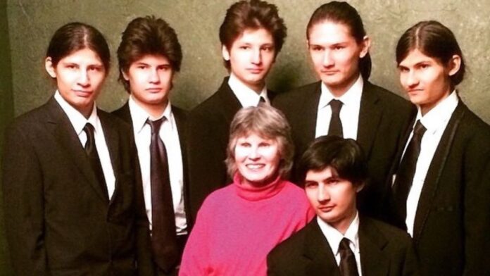 The Wolfpack brothers posing in black suite with their mother.