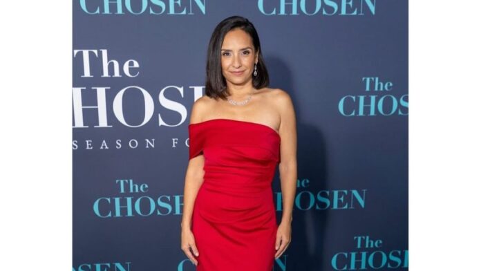 Vanessa Benavente at an event wearing stunning red gown.